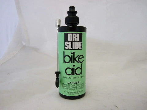 Dri-Slide Dry Moly Lube 4 Oz bottle with needle nozzle, labeled bike aid. Perfect for bike chains, cables, and moving parts.