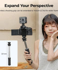 Person using Multifunction Wireless Shooting Grip With Adjustable Selfie Stick And Integrated Remote with camera setup
