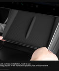 Tesla Model Y Juniper Center Console Qi Wireless Charging Pad with Non Slip Silicone Mat being installed in Model Y.