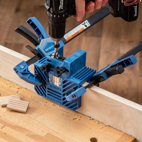 One Handed 10 Inch Bar Clamp With Spring Loaded Trigger Grip holding wood during drilling, hands free use, blue nylon material