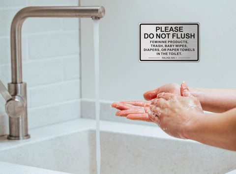 Two Pack Do Not Flush Sign For Bathroom Self Adhesive Aluminum Metal Sign With Brushed Aluminum Black Finish 9 By 6 Inches Perfect For Restrooms In Offices Restaurants And Homes displayed beside a faucet.