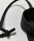 Keep Your Rig Running Smooth With This Hella Reliable EV Charger Plug Port Cover featuring a black J1772 dust cap with zip tie mounts.