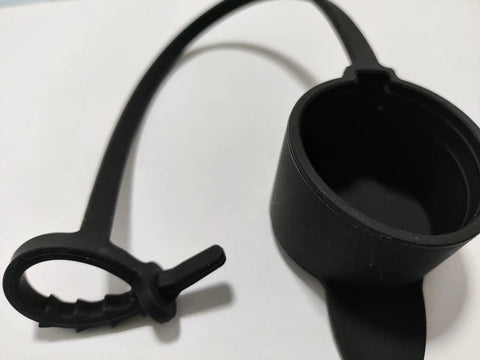 Keep Your Rig Running Smooth With This Hella Reliable EV Charger Plug Port Cover featuring a black J1772 dust cap with zip tie mounts.