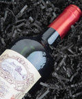 Hassle Free Black Crinkle Cut Paper Shred Filler For Gift Baskets And Boxes Smooth Cushion Wrapper surrounding a wine bottle.