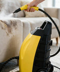 Quick Heat Up Yellow Steam Cleaner With Full Attachments For Multi-Spot Use 3000 Watt High Power Motor in use on couch upholstery.