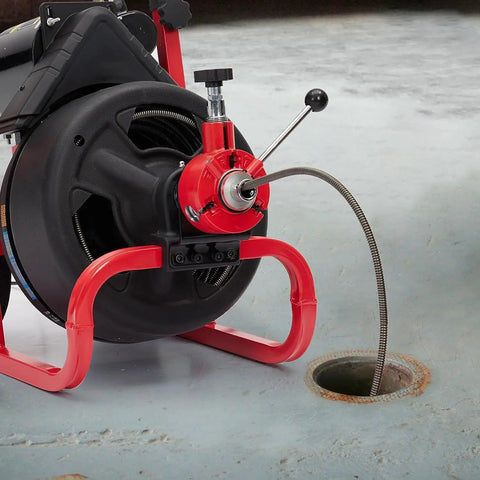 Heavy Duty Workhorse Electric Drain Auger Machine With Automatic Forward And Reverse Footswitch Control Plug And Play Badass Performance For Pro Plumbers One Hundred Feet By Three Eighths Inch Steel Cable Six Sharp Cutters at drain opening.