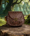 Vintage Brown Faux Leather Medieval Belt Pouch Featuring Carved Elven Leaf Details on a wooden stump in a forest setting.