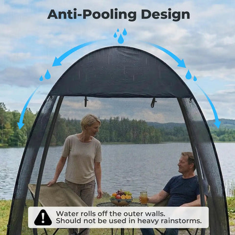 Pop Up Screen Tent 6x6 Feet Black Mesh Gazebo With Peaked Roof shown outdoors by a lake with two people seated inside.