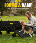Foldable Dog Wagon Cart With Drop-Down Tailgate, Heavy Duty All-Terrain Wheels in park with dog using tailgate ramp