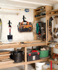 Four Pack Horse Bridle Rack Hooks holding a saw, shovel, and tool bag on a workshop wall, heavy duty metal wall mount for storage