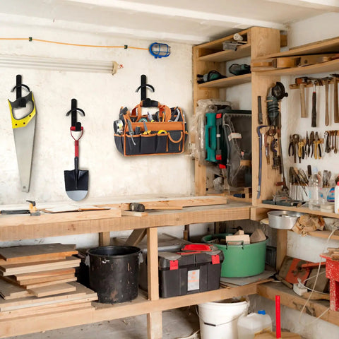Four Pack Horse Bridle Rack Hooks holding a saw, shovel, and tool bag on a workshop wall, heavy duty metal wall mount for storage