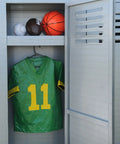 Open locker with sports balls and green football jersey number 11