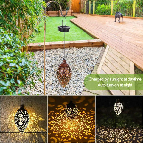 Olive Shaped Hanging Solar Lantern With LED Garden Lights casting decorative patterns on outdoor patio and pathway.