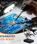 Person using Desktop LED Magnifying Glass Soldering Station with Handy Helping Hands on a circuit board, 2.5X 7.5X 10X Magnifier shown