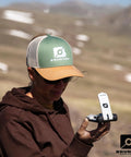 Person holding TruArc 20 Luminous Expedition Compass With Glow In The Dark Sighting Tool And Protective Boot