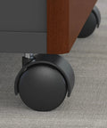 Close-up of wheel on Series C 3 Drawer Rolling File Cabinet In Hansen Cherry Fully Assembled Under Desk Storage With Wheels
