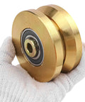 Built Like A Tank 4 Inch Sliding Gate Rollers Wheels 2 Pack shown in hand, gold V groove wheels with sealed bearings