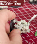 One Box Fits All Hobby Tool Kit With Glue And Six Essential Tools For Miniature Assembly in use on a model with sculpting tool