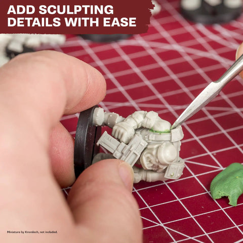 One Box Fits All Hobby Tool Kit With Glue And Six Essential Tools For Miniature Assembly in use on a model with sculpting tool