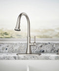 Kaori Single Handle Kitchen Faucet With Pull Down Sprayer And Soap Dispenser In Vibrant Stainless Finish installed on granite countertop