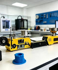Turn Leftover Plastic Bits Into Quality Filament With This Compact 3D Printer Filament Extruder Machine on a workbench with spools.