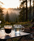 Six Pack Double Wall Insulated Espresso Cups With Handles Clear Borosilicate Glass Shot Glasses shown on a table outdoors