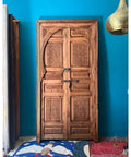 Handcrafted Barn Door In Your Size Dope Sliding Or Hinged Interior Exterior Front Door With That Vintage Meets Modern Farmhouse Vibe Made To Order 71 By 34 Inches No Glass Or Hardware Included Customizable in carved wood against a blue wall.