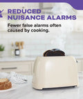 Smoke rising from a toaster with burnt toast, demonstrating reduced nuisance alarms of Hardwired Smoke And Carbon Monoxide Alarm With Voice Alerts, 10 Year Sealed Battery Backup, Interconnected Combo Fire And CO Detector, Model 30CUA10 V, Easy Install, UL Listed, Includes Cloth in a kitchen setting.