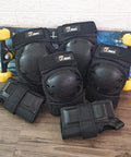 Knee Pads Elbow Pads And Wrist Guards Full Protective Gear For Skateboarding Inline Skating And Scooter For Ages 12 And Up Durable Hard PP Shell With Thick EVA Foam Padding Adjustable Straps Black in front of skateboard