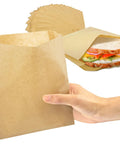 Hand holding Greaseproof Paper Sandwich Bags 200 Pack 7 By 6 By 1 Inches Unbleached Brown Bags For Bakery Donuts.