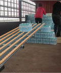 Gravity Conveyor System For Light Duty Loads With Unloading Pulley ABS Rollers And Stainless Steel Frame in use, transporting water packs
