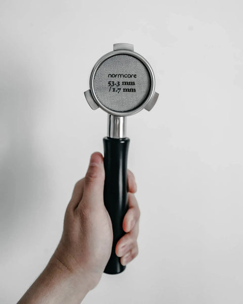 Hand holding Espresso Puck Screen For 54mm Portafilter Lower Shower Screen 53.3mm Fit 316 Stainless Steel 1.7mm Thick 150 Micron Layer