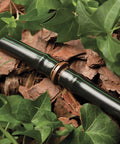 Pro Grade One-Half Inch Drip Irrigation Distribution Tubing Fifty Foot Roll in black among green leaves and mulch