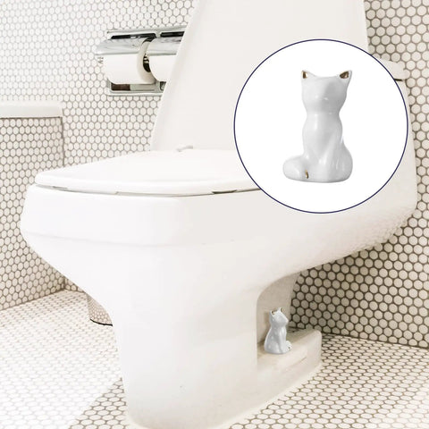 Level Up Your Bathroom Vibe With This Dope Set Of Ceramic Cat Toilet Bolt Covers And Floor Screw Caps Rust Proof Maximalist Accent For Hiding Ugly Base Screws Forever, showcasing a white ceramic cat cover on a toilet base.