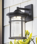 10.25 Inch Black And Clear Outdoor Wall Lantern With Integrated LED, Modern Farmhouse Exterior Sconce; clear crackled glass shade, ETL listed.