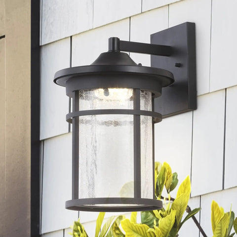 10.25 Inch Black And Clear Outdoor Wall Lantern With Integrated LED, Modern Farmhouse Exterior Sconce; clear crackled glass shade, ETL listed.