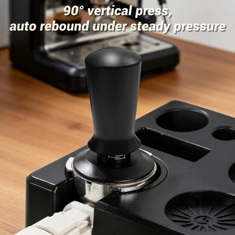 Game Changer 51 Mm Espresso Accessory Bundle featuring a 90° vertical press tamper on a barista station for espresso preparation.