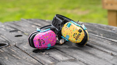 Razor Earmuffs With Sound Amplification, ultra slim ear cups, one size fits most, golden brown sprinkles and purple design.