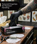 Badass 6 Mil Black Nitrile Gloves, Tough As Nails Heavy Duty Disposable Work Gloves With Unbeatable Textured Grip For Auto Shop Grinds And Weekend Projects, Powder And Latex Free, Case Of 100 being pulled from a box.