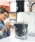 Woman using 4L Filament Dryer Box For 3D Printer Spools Dehydrator And Storage For PLA PETG ABS TPU Filaments with 3D printer.