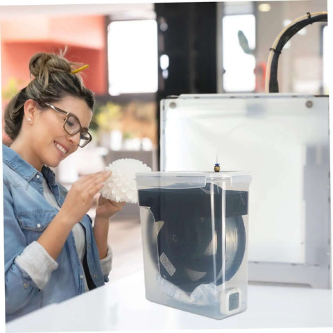 Woman using 4L Filament Dryer Box For 3D Printer Spools Dehydrator And Storage For PLA PETG ABS TPU Filaments with 3D printer.