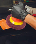 Heavy Duty VOSAREA Bench Grinder Buffing Wheel With Nonwoven Abrasive Cloth polishing a car surface using a power tool.