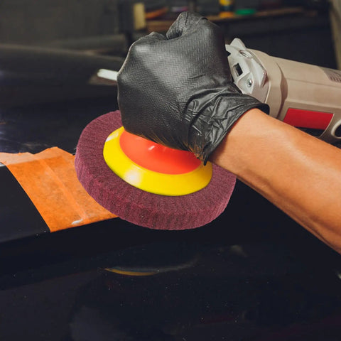 Heavy Duty VOSAREA Bench Grinder Buffing Wheel With Nonwoven Abrasive Cloth polishing a car surface using a power tool.