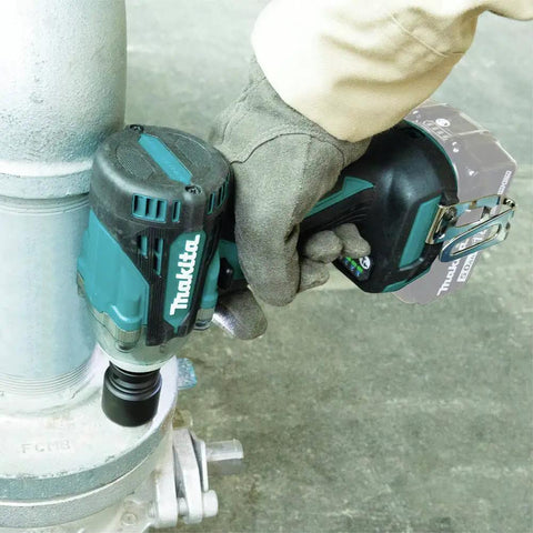 18V LXT Brushless Cordless Three Eighths Inch Drive Impact Wrench with Friction Ring Anvil in use on a pipe