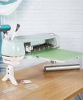 White extension tray for Cricut Maker/Explore series, 12x12 cutting mat holder beneath a mint-colored cutting machine.