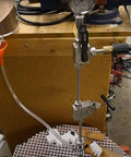 DIY waterjet cutting head assembly with mixing chamber, nozzle body, and collet on vertical stand with pressure gauge