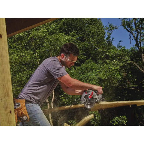 Worker using Heavy Duty 7-1/4 Inch Circular Saw With 15 Amp Motor Delivers 5500 RPM Magnesium Shoe And Metal Guards for cuts.