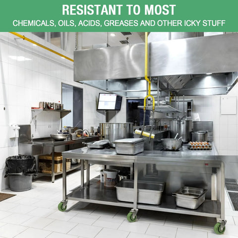 Industrial kitchen with stainless steel equipment and high temperature caster wheels for heavy duty use, resistant to chemicals and grease.