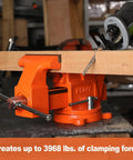 Heavy Duty 5 Inch Bench Vise With Swivel Base And Anvil, Multi Jaw Clamp in use clamping a wooden board in a workshop