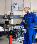 HDLNKAK digital bore gauge with LCD display, black, held by a mechanic beside an engine block